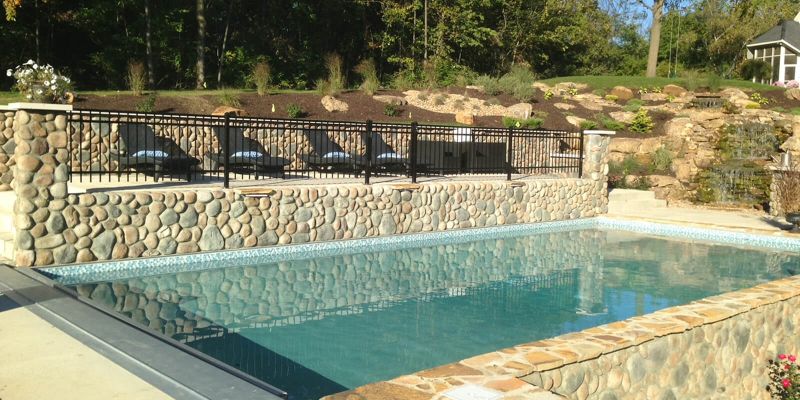 An in ground pool with beautiful blue water on a sunny day.